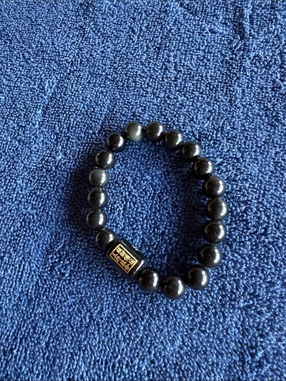 Black Onyx beaded Stretch Bracelet with Gold Accent. Chinese characters